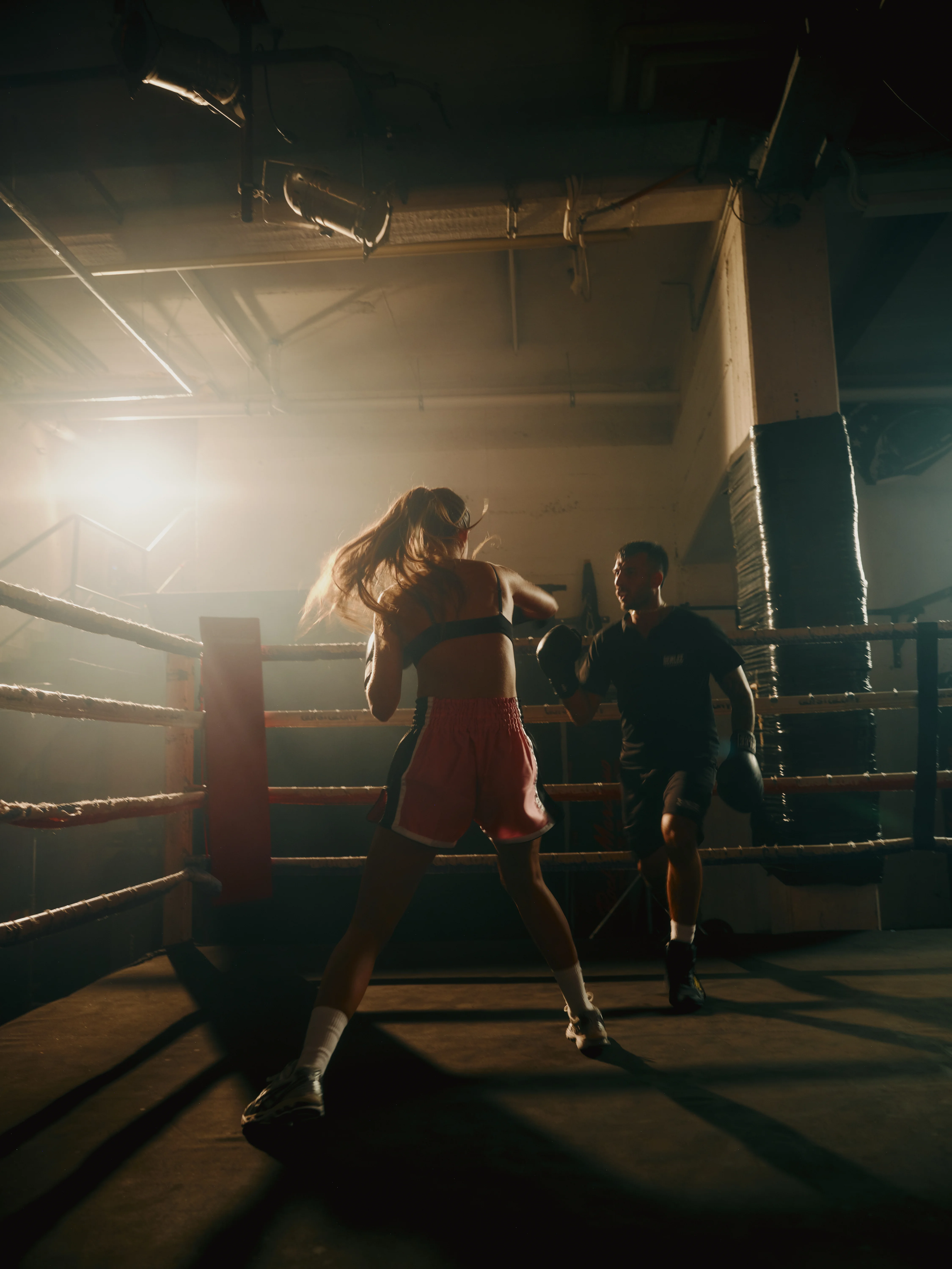Sparring in the ring under warm light