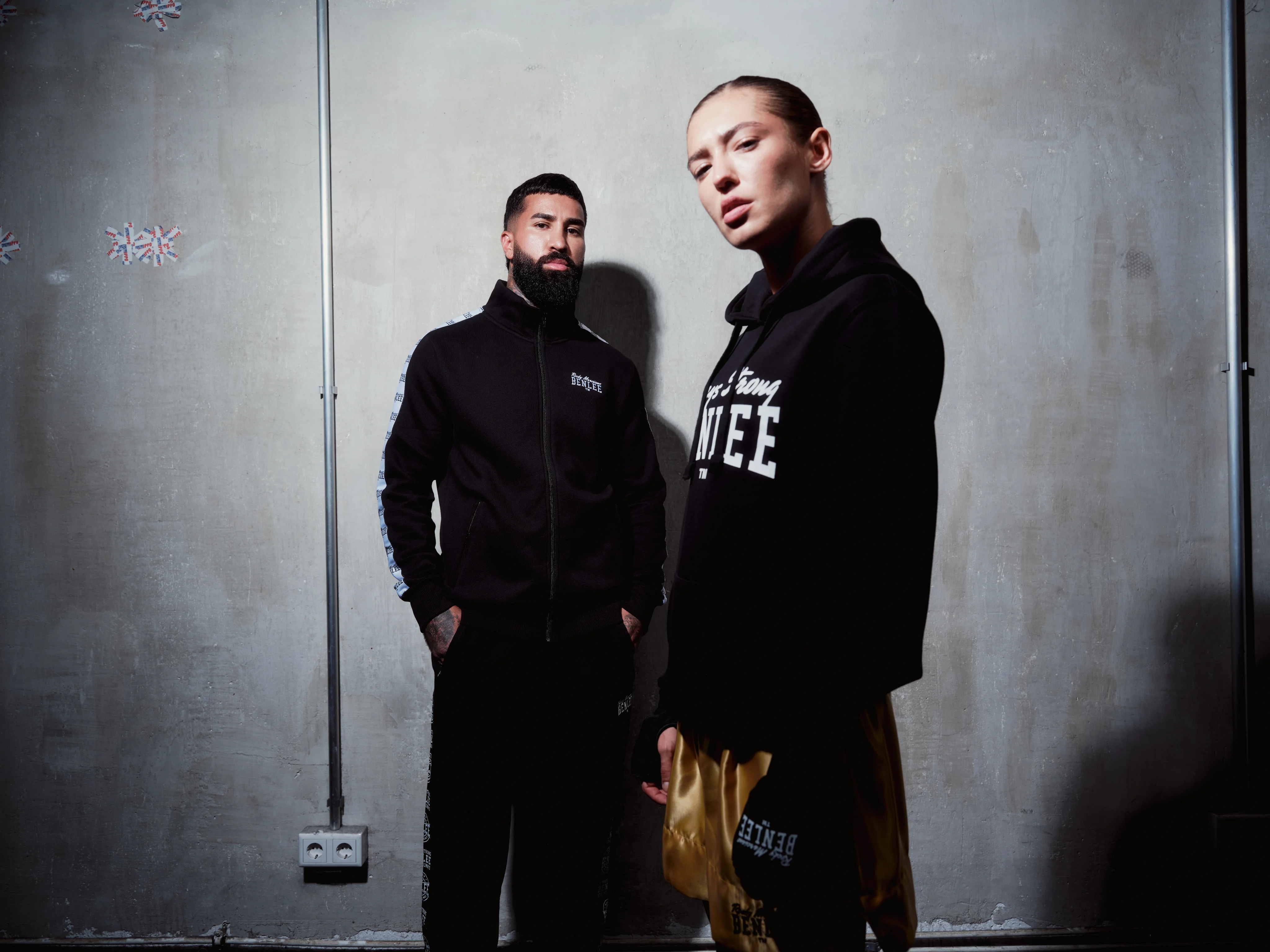 Two boxers in black BENLEE hoodies against a concrete wall