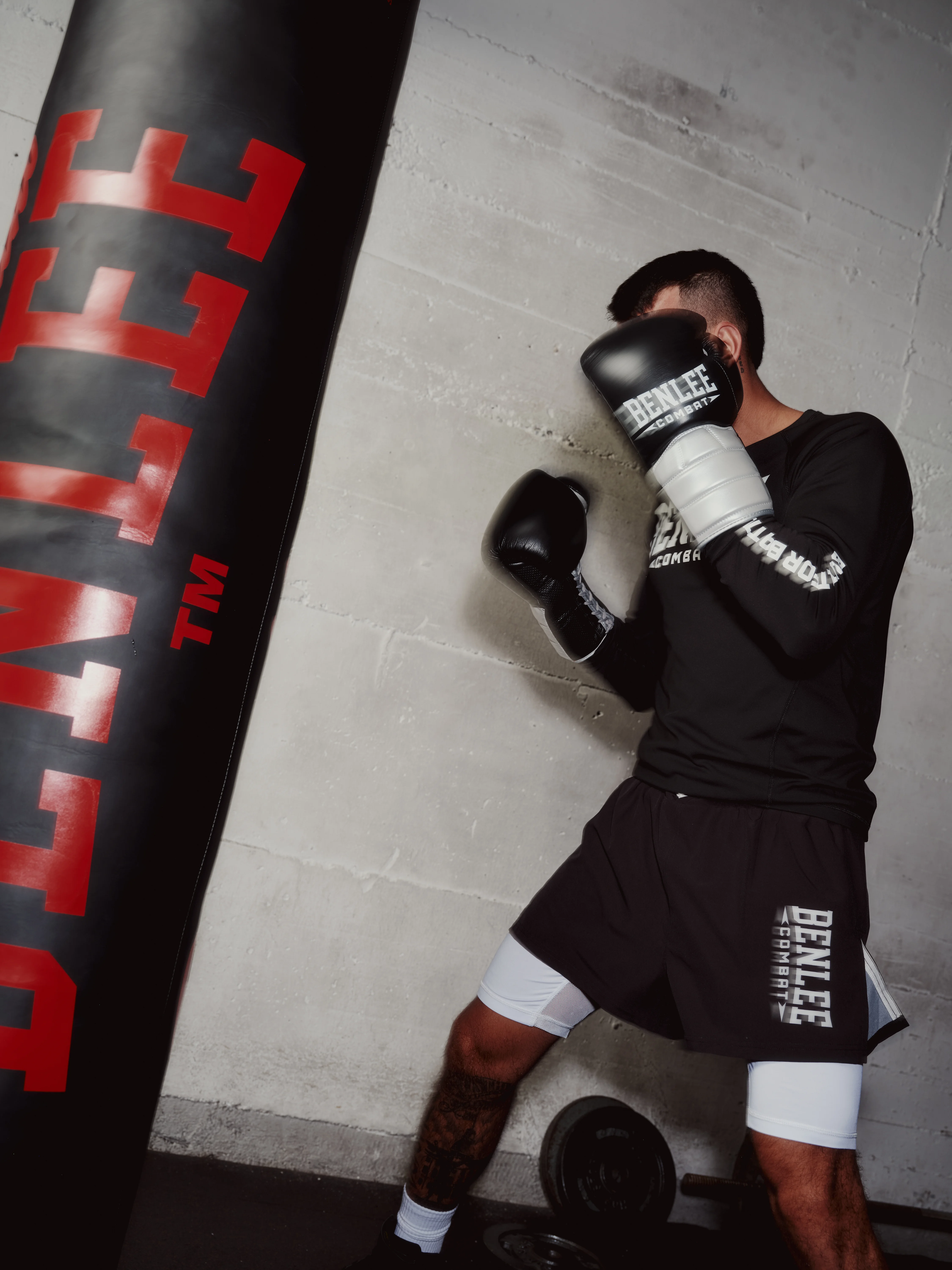 Boxer in guard next to a heavy bag