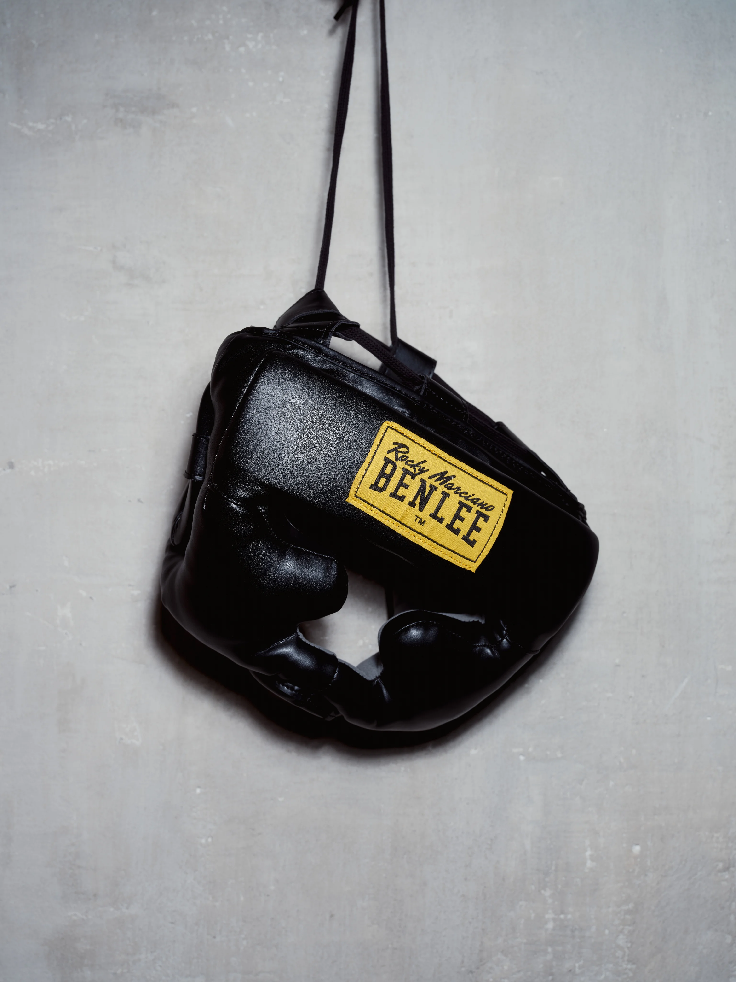 BENLEE headgear hanging on a concrete wall