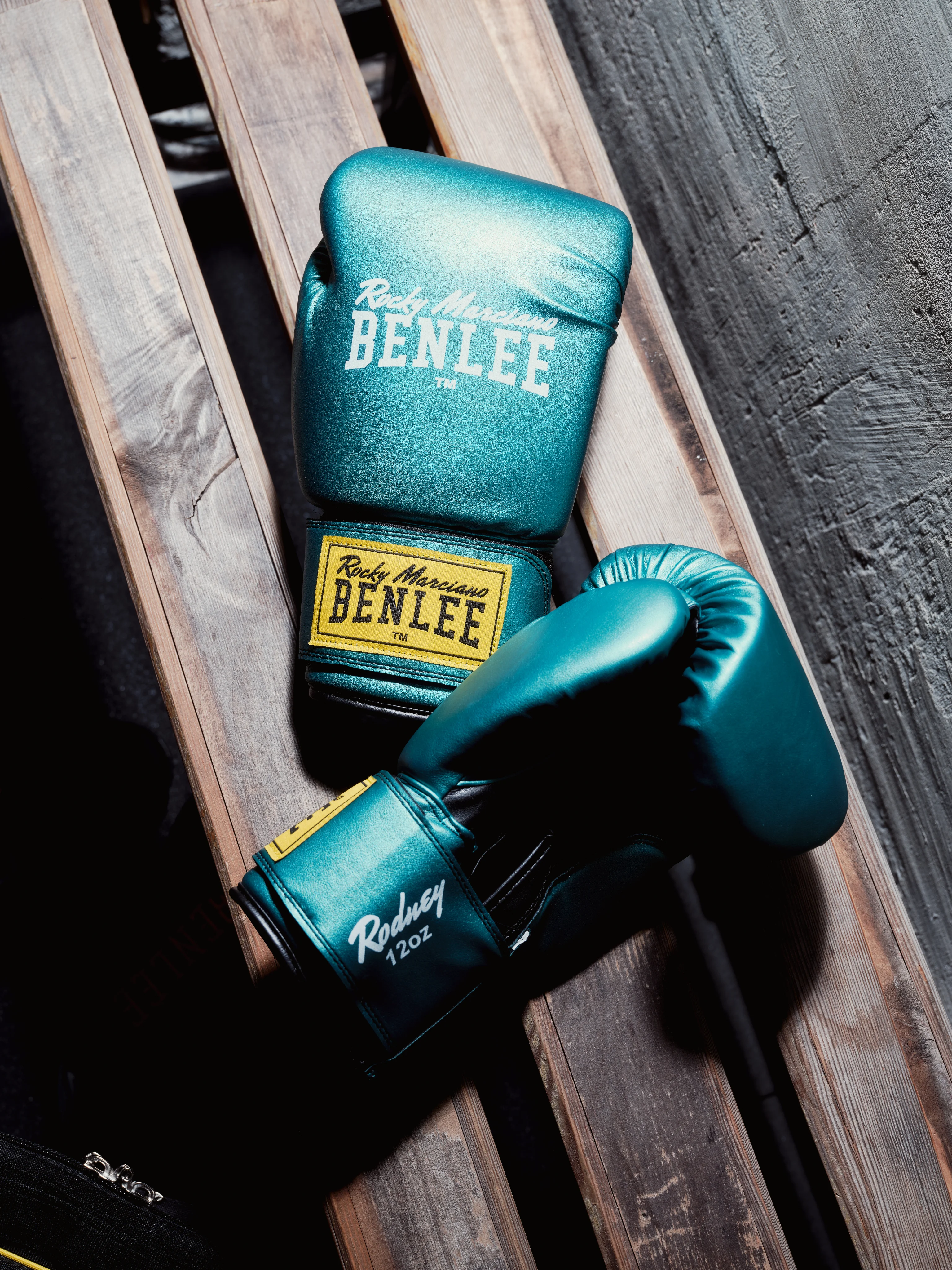 Teal BENLEE gloves on wooden slats