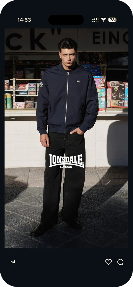 Lonsdale story ad: man in a navy jacket and black trousers in front of a kiosk