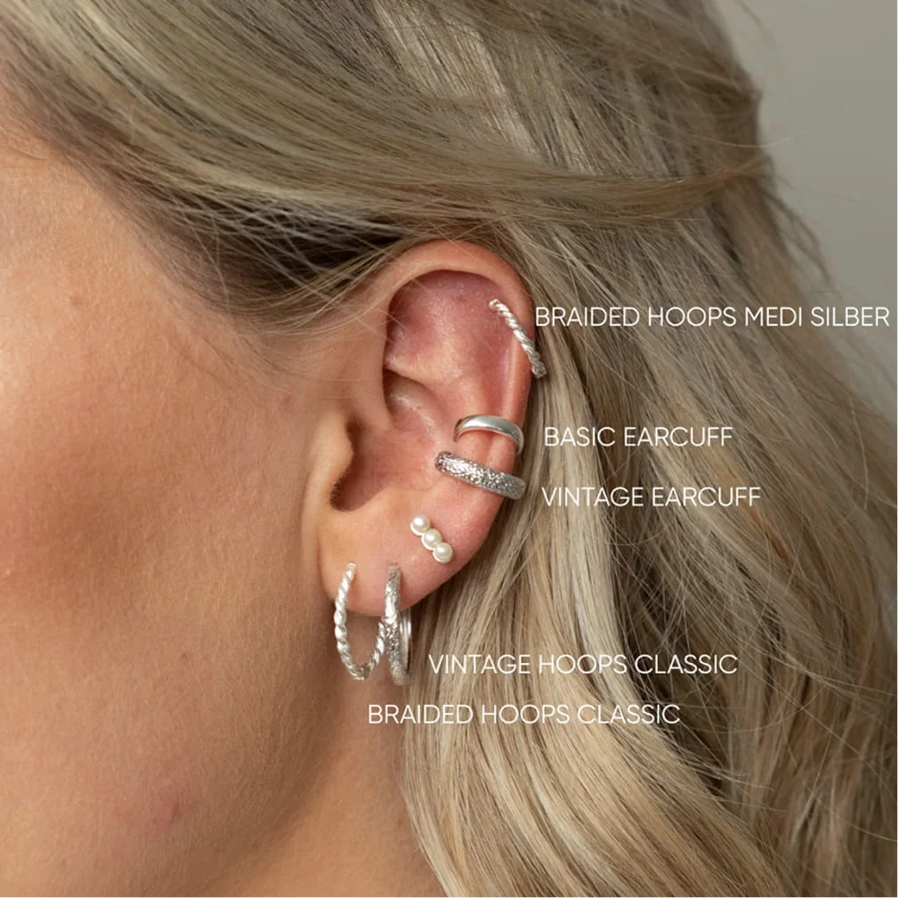 Fafe Collection ad: silver hoops and ear cuffs on an ear, each labeled