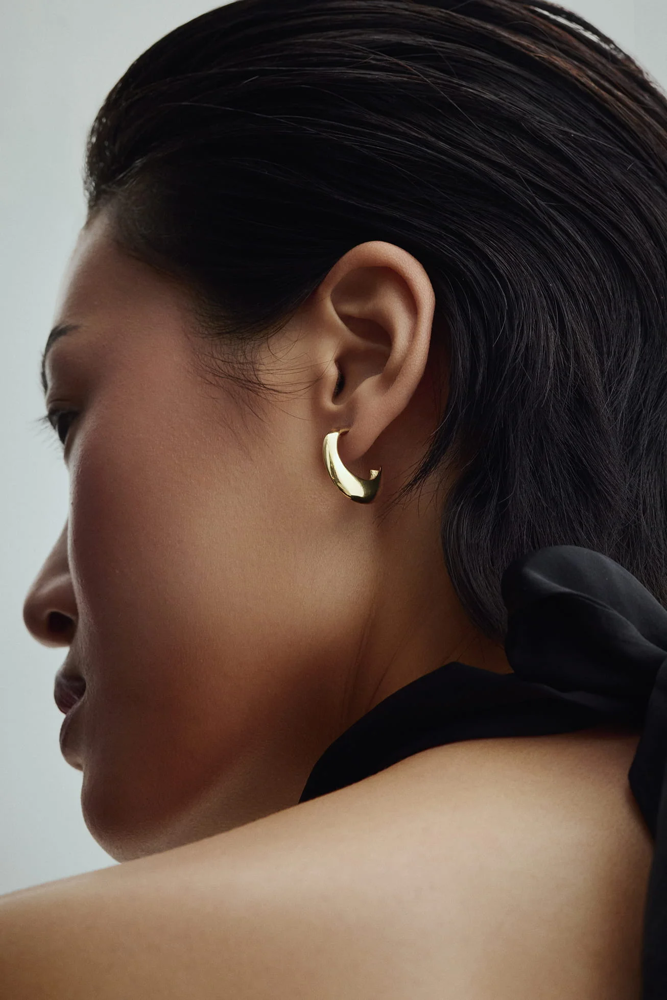 Gold hoop earring on a woman’s ear