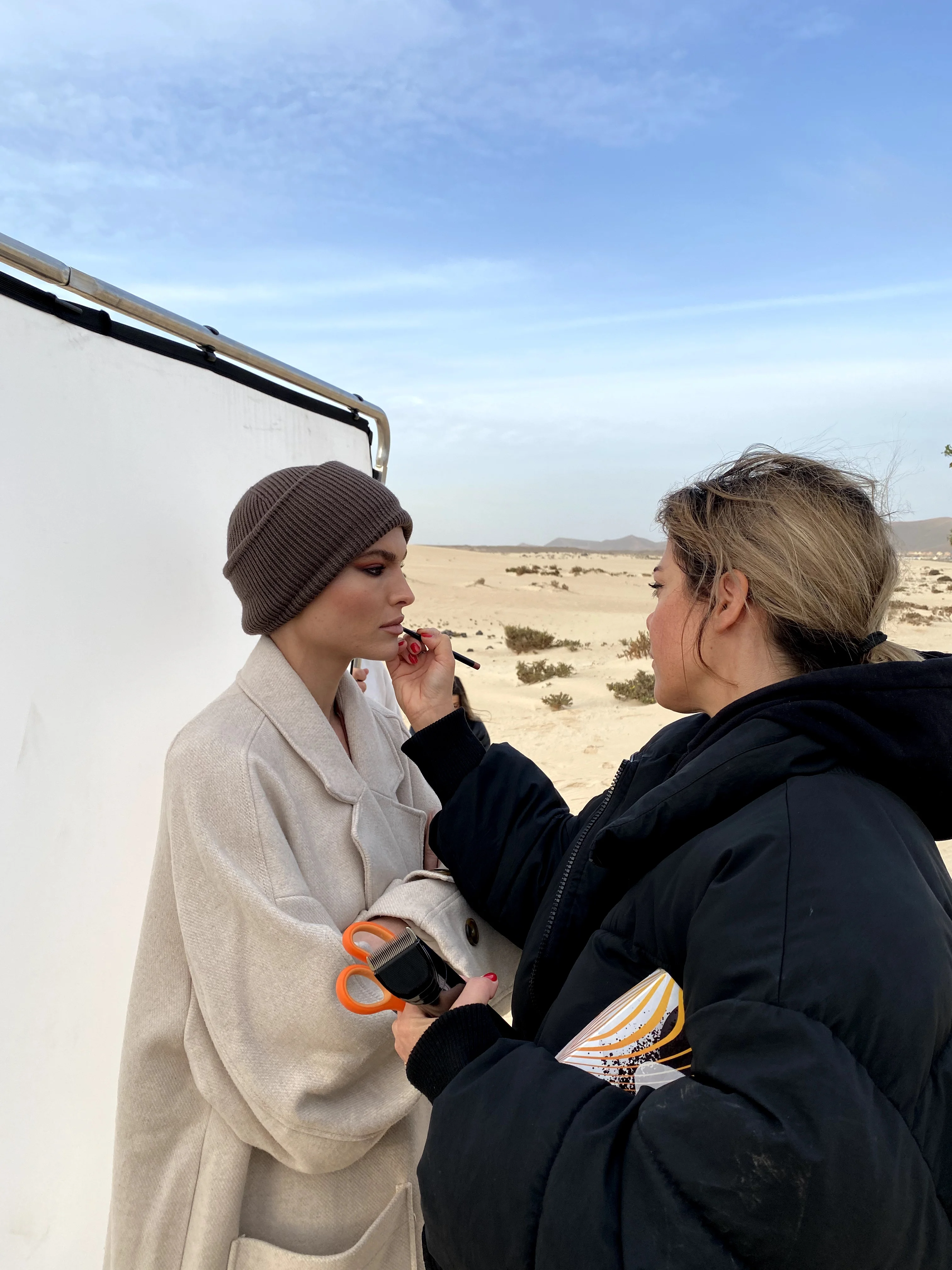 Make-up touch-up for a model on a desert location
