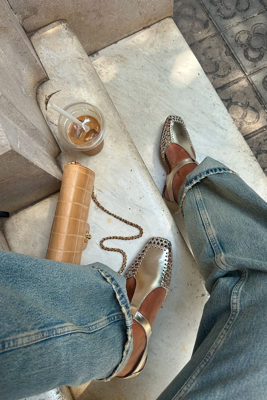 Metallic sandals, tan bag, and iced coffee.