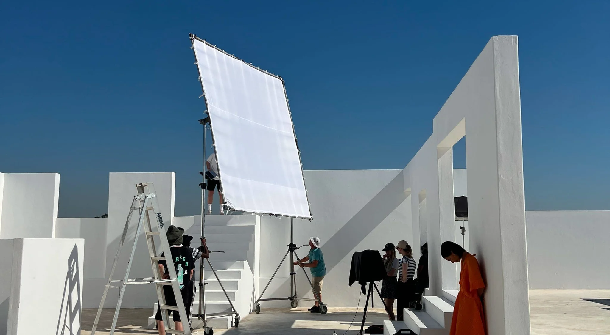 Production set with a reflector on a white rooftop in Cape Town