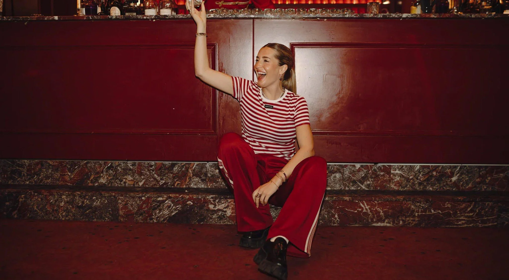 Karo Kauer the Label: model in a striped shirt in a red interior