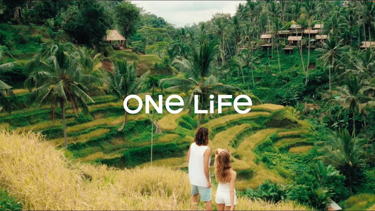 Still from the ONE LIFE film: a woman and a child in front of rice terraces.