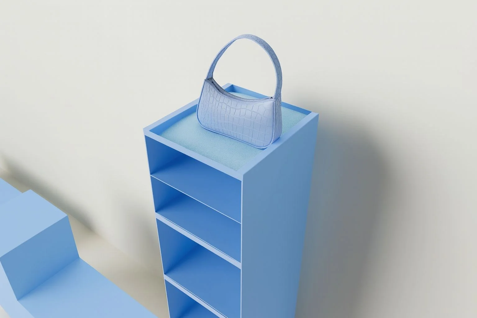 Display shelf wrapped in blue with a handbag on top