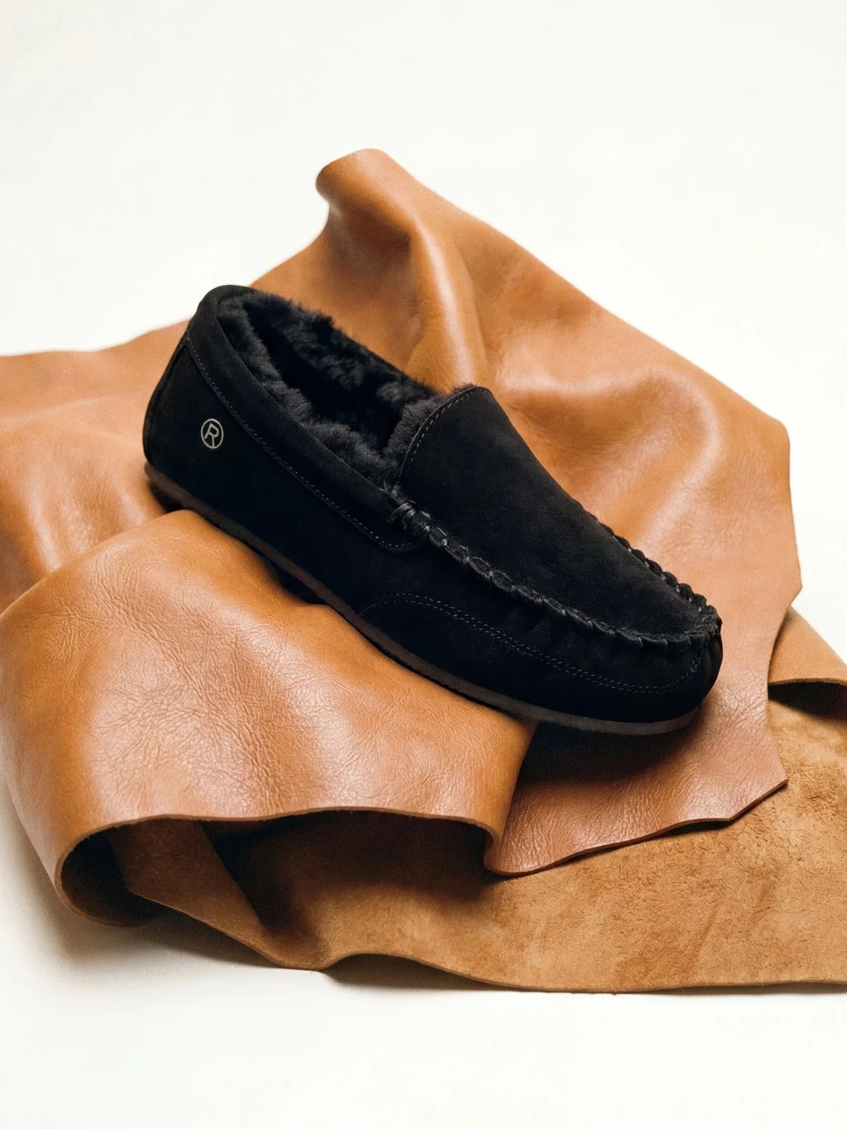 Black suede moccasin with shearling lining on tan leather