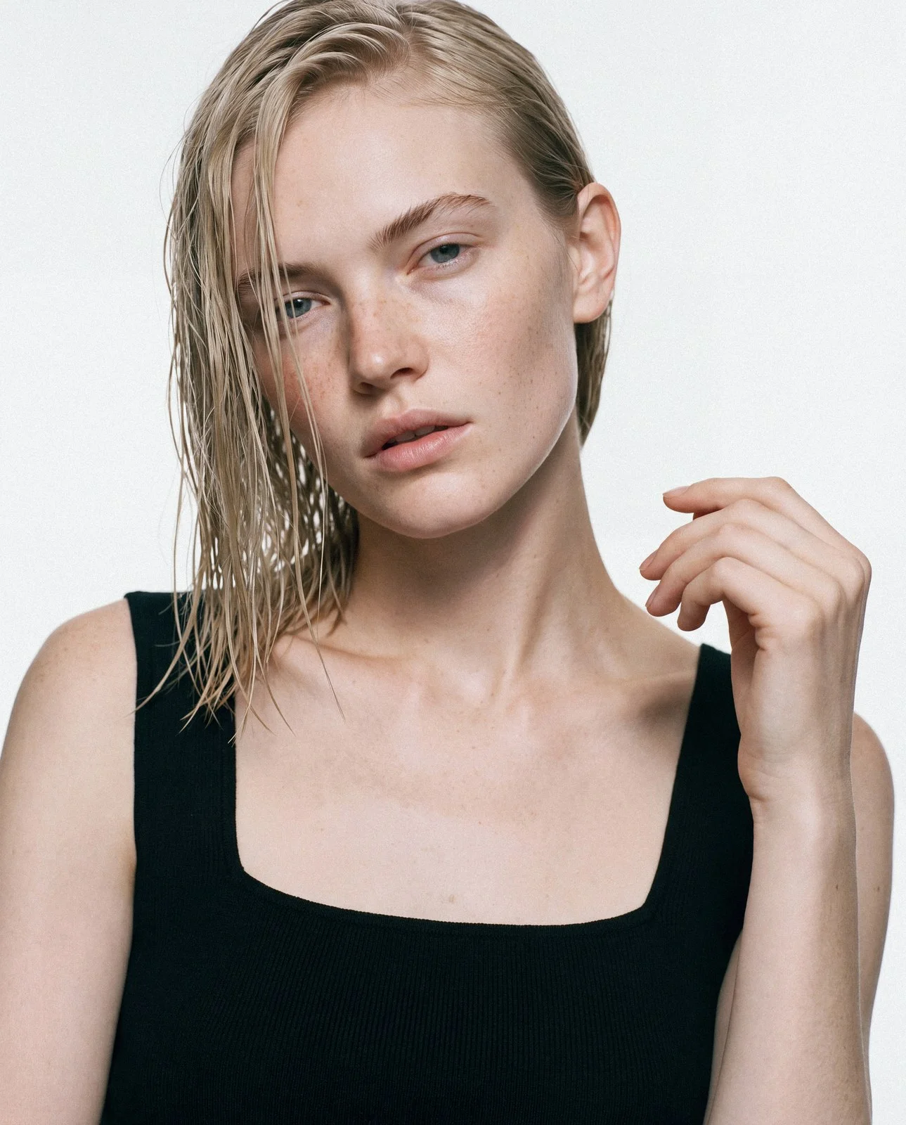 Blonde model with wet hair in a black tank top