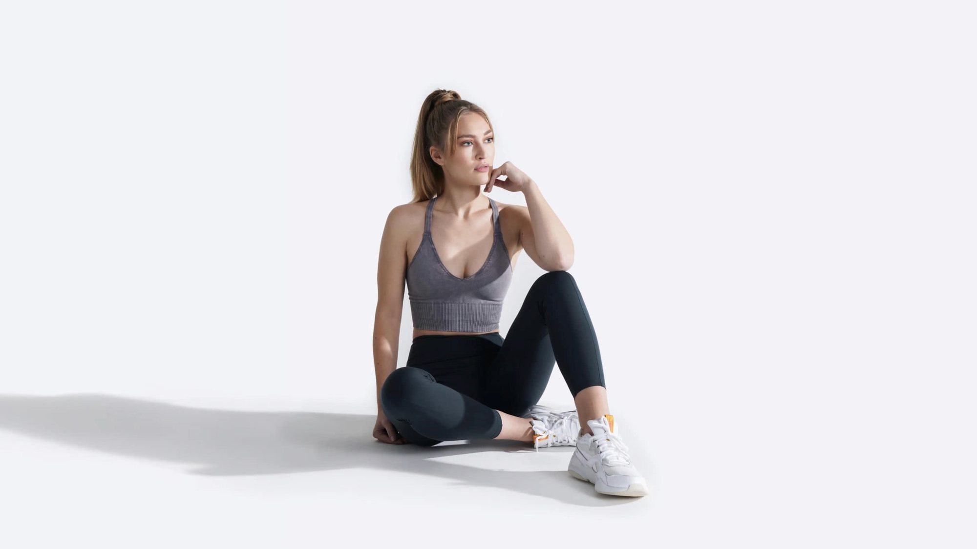 Woman in athletic wear on white background