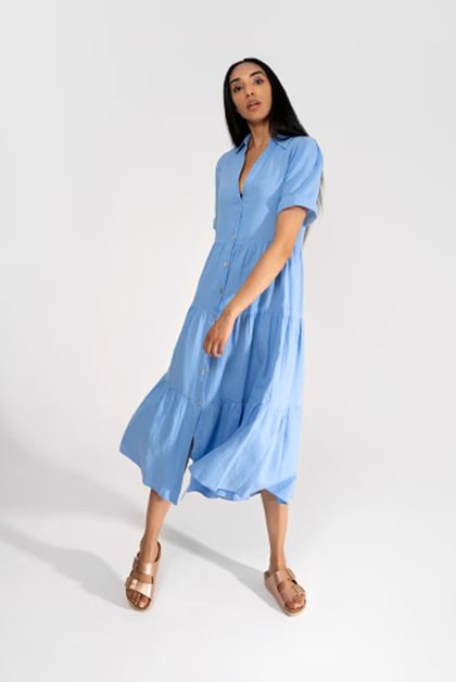 Model in light blue tiered midi dress and sandals
