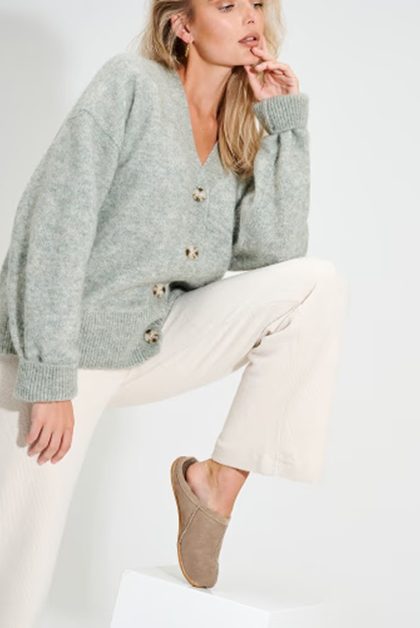 Woman in cardigan and slippers