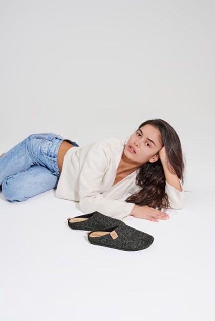 Model with slippers, jeans and jacket