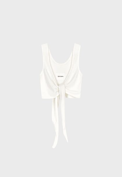 White tie-front tank top with a small logo patch