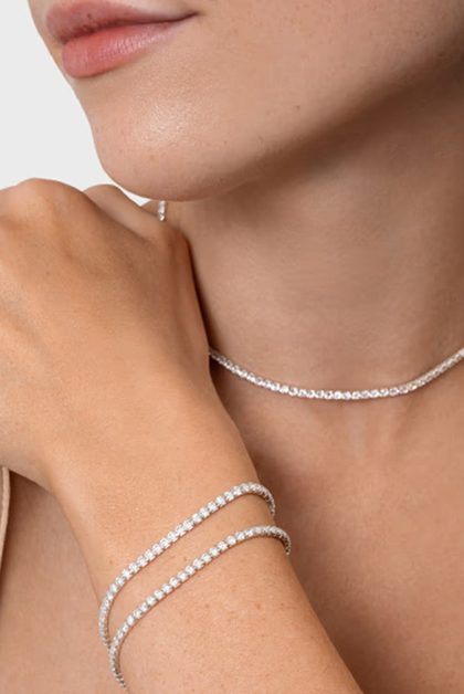 Silver tennis bracelets and necklace on model