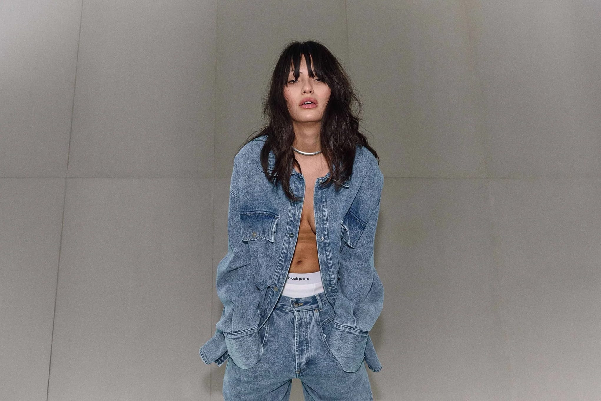Denim-clad model with bare midriff