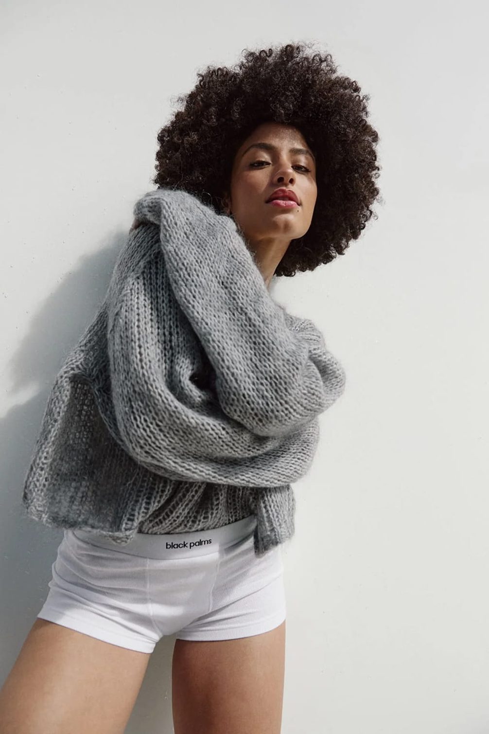 Model in chunky knit sweater and underwear