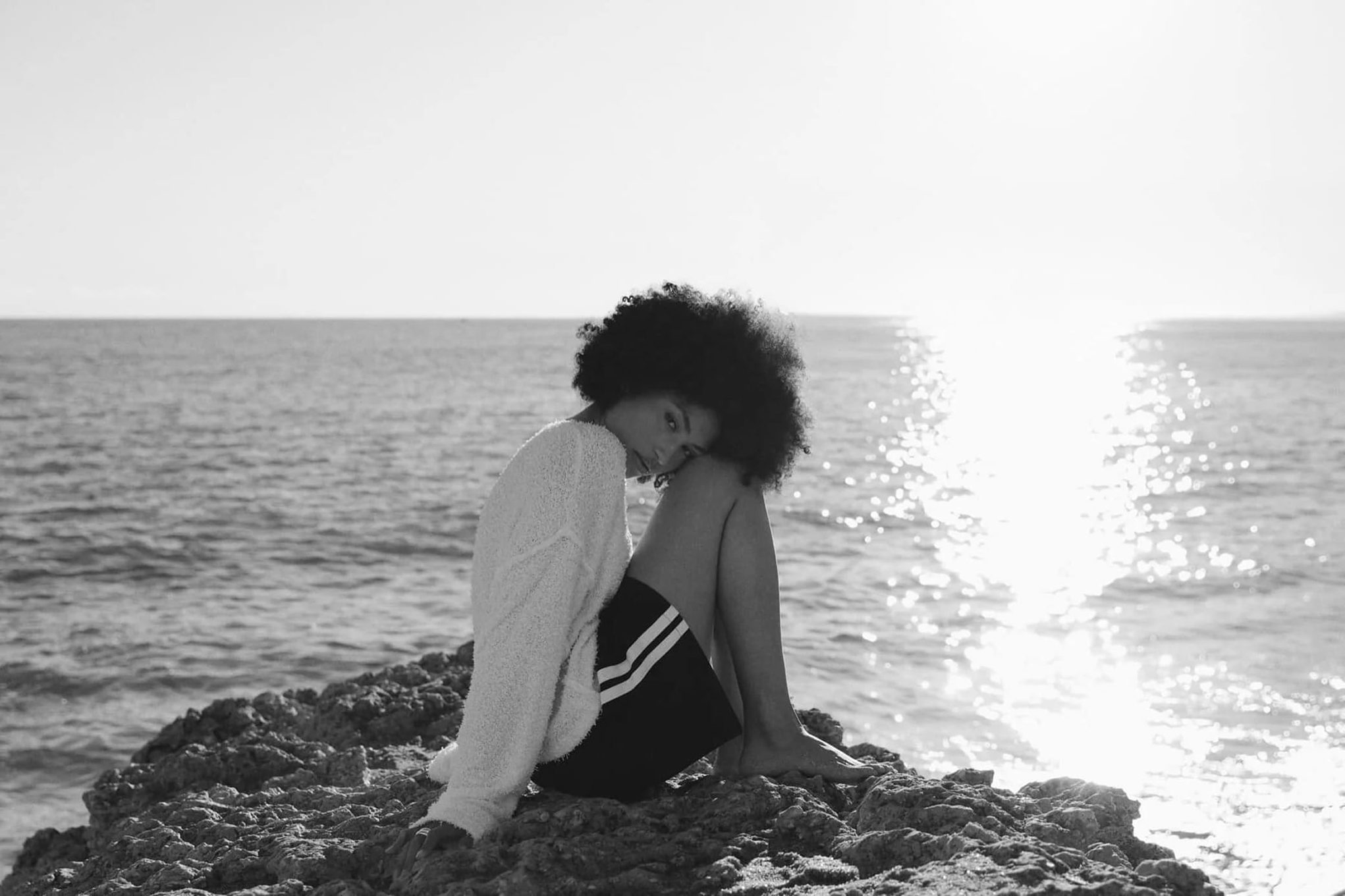 Fashion model on rocks by the sea