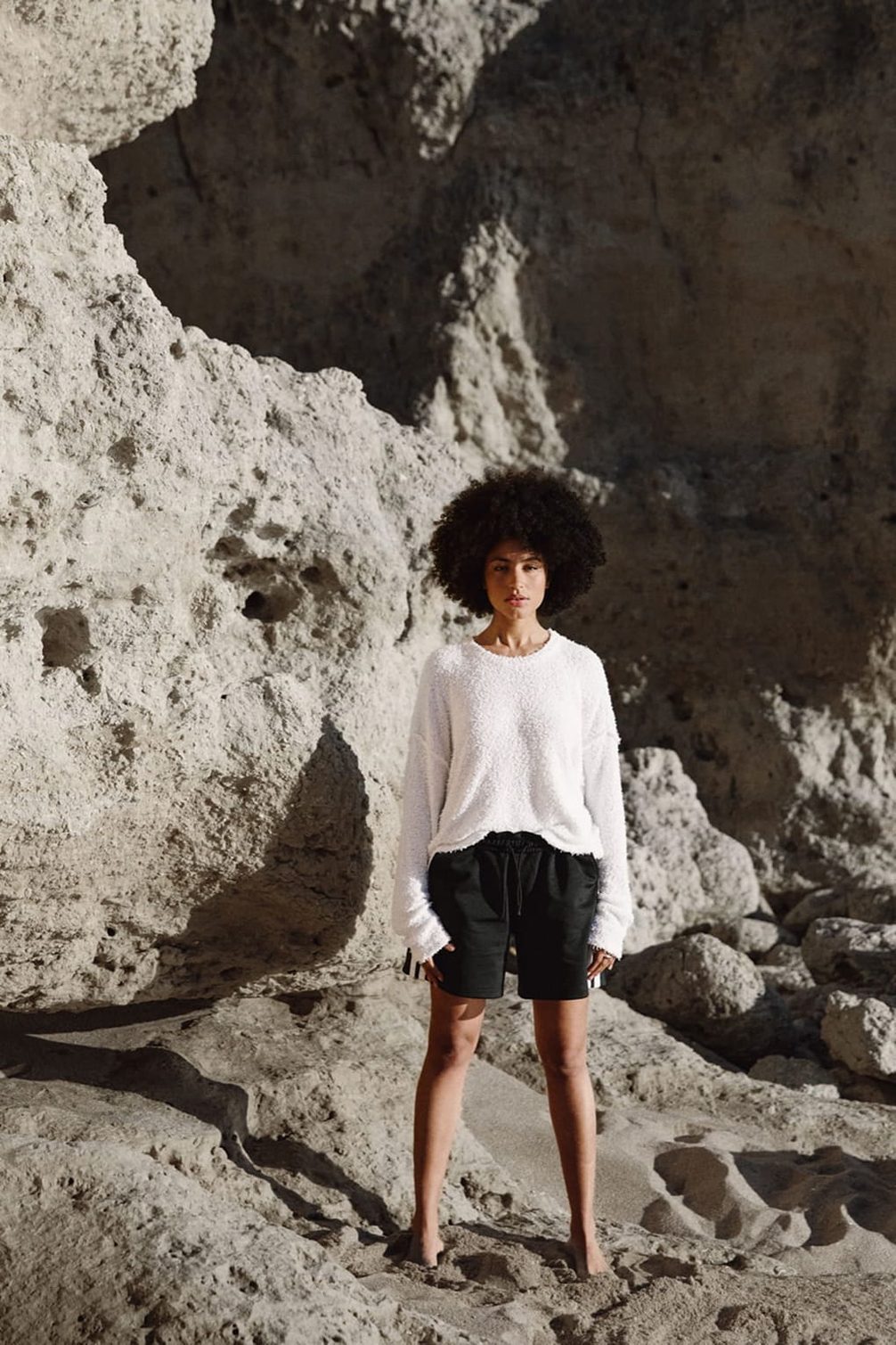 Fashion model on beach rocks