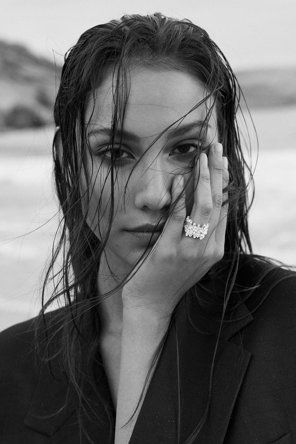 Woman with wet hair and a ring on her hand