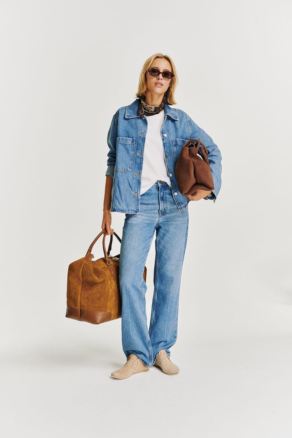 Model with denim outfit and bags