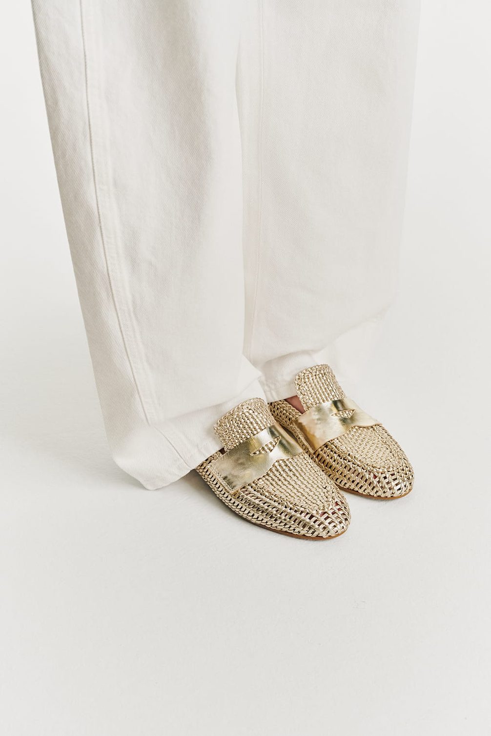 Gold woven mules with metallic band accent