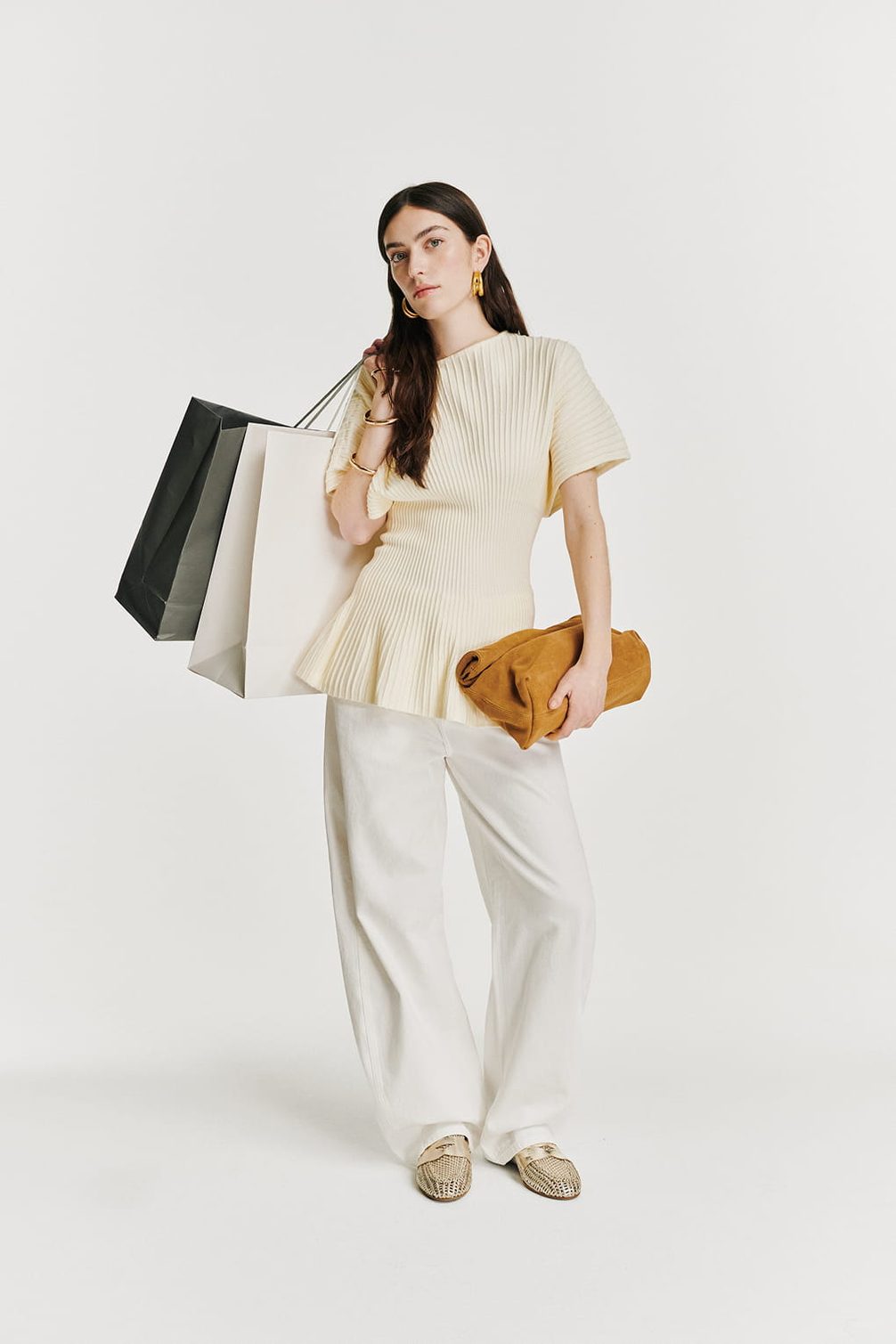 Woman with shopping bags and clutch