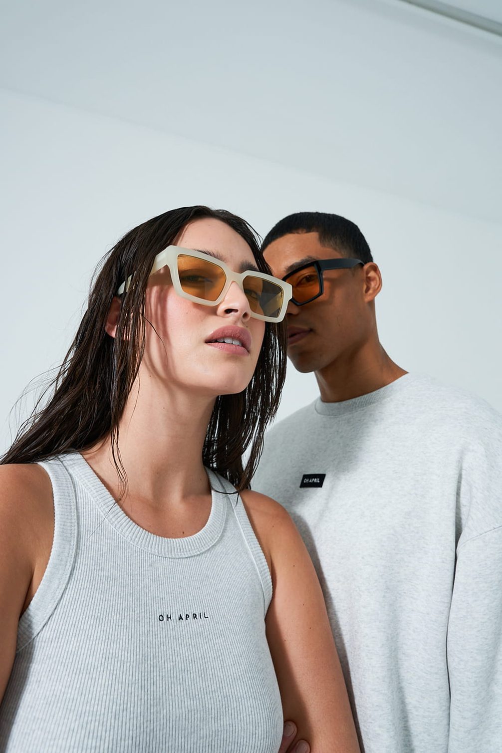Fashion duo in sunglasses, modeling "OH APRIL".