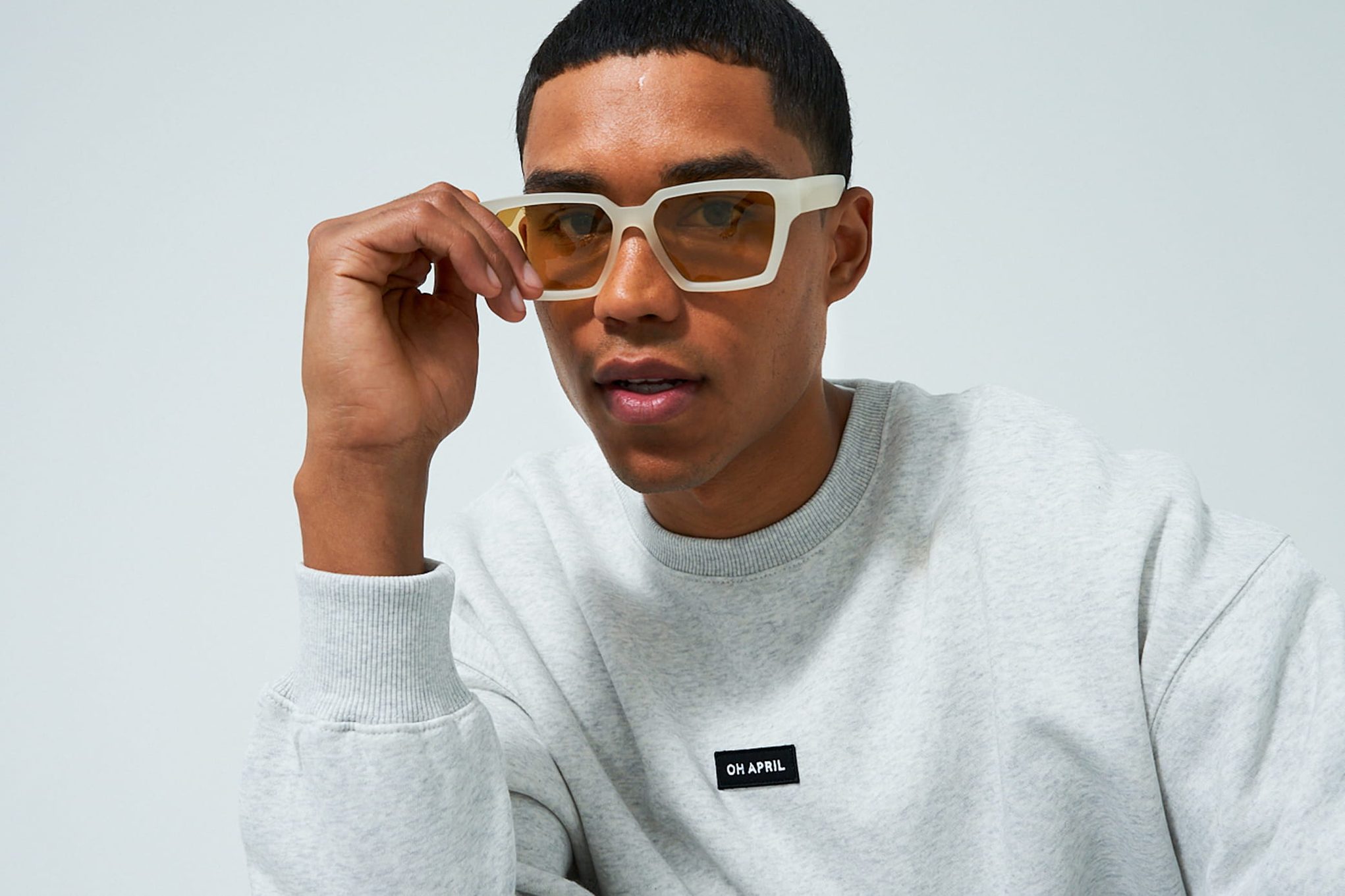 Model in trendy sunglasses, crewneck sweatshirt