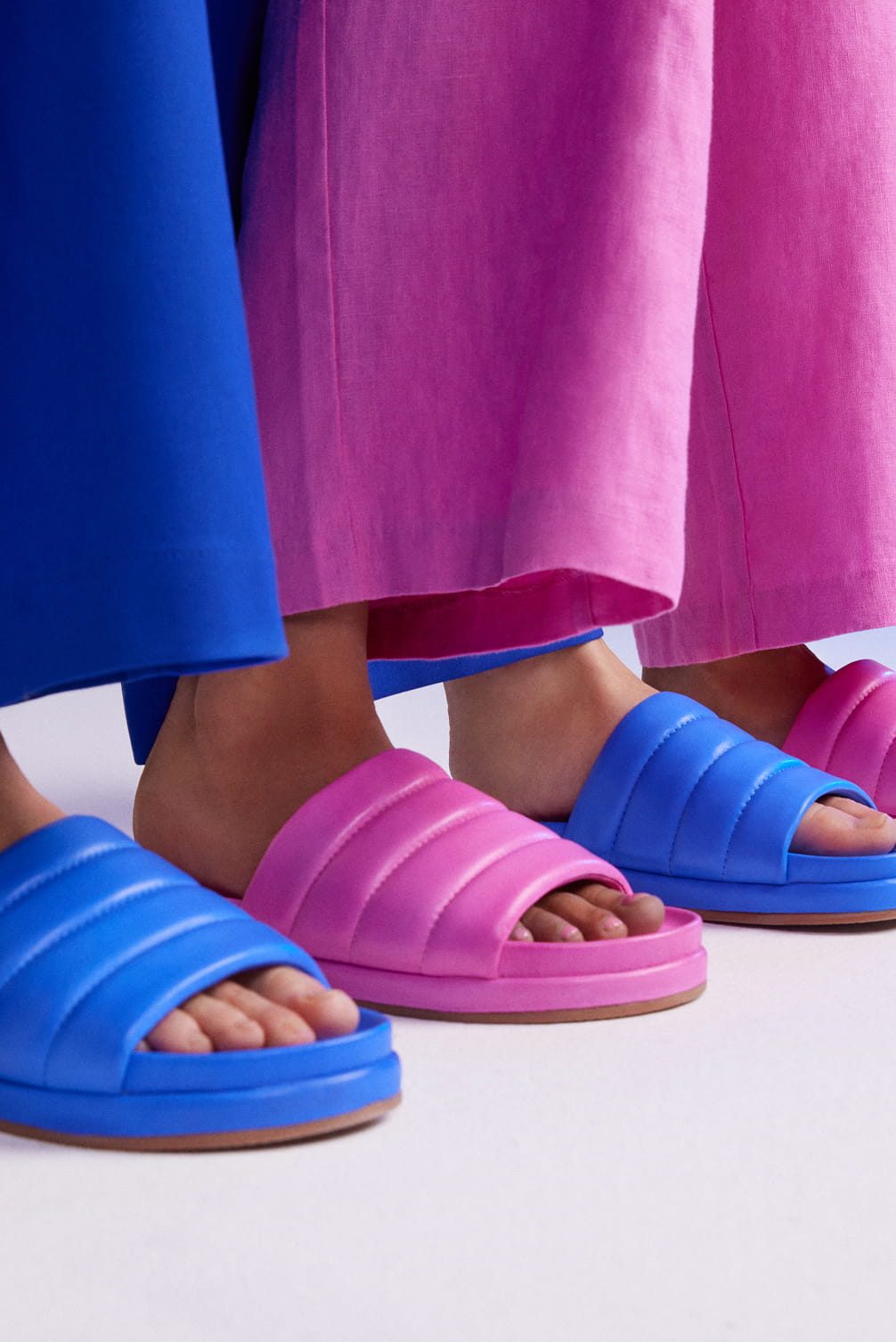 Padded slides in pink and blue.