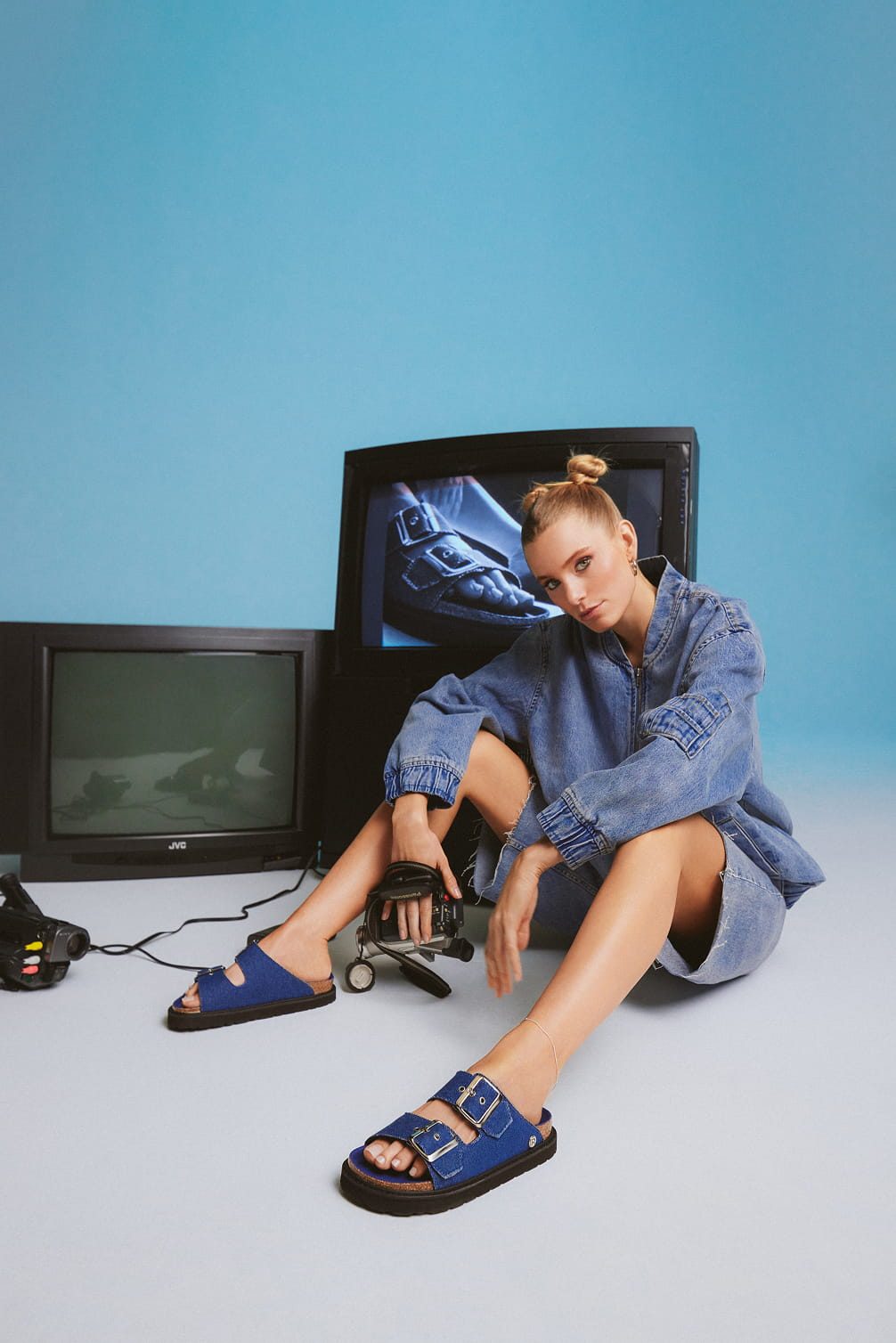 Woman in denim outfit with vintage electronics