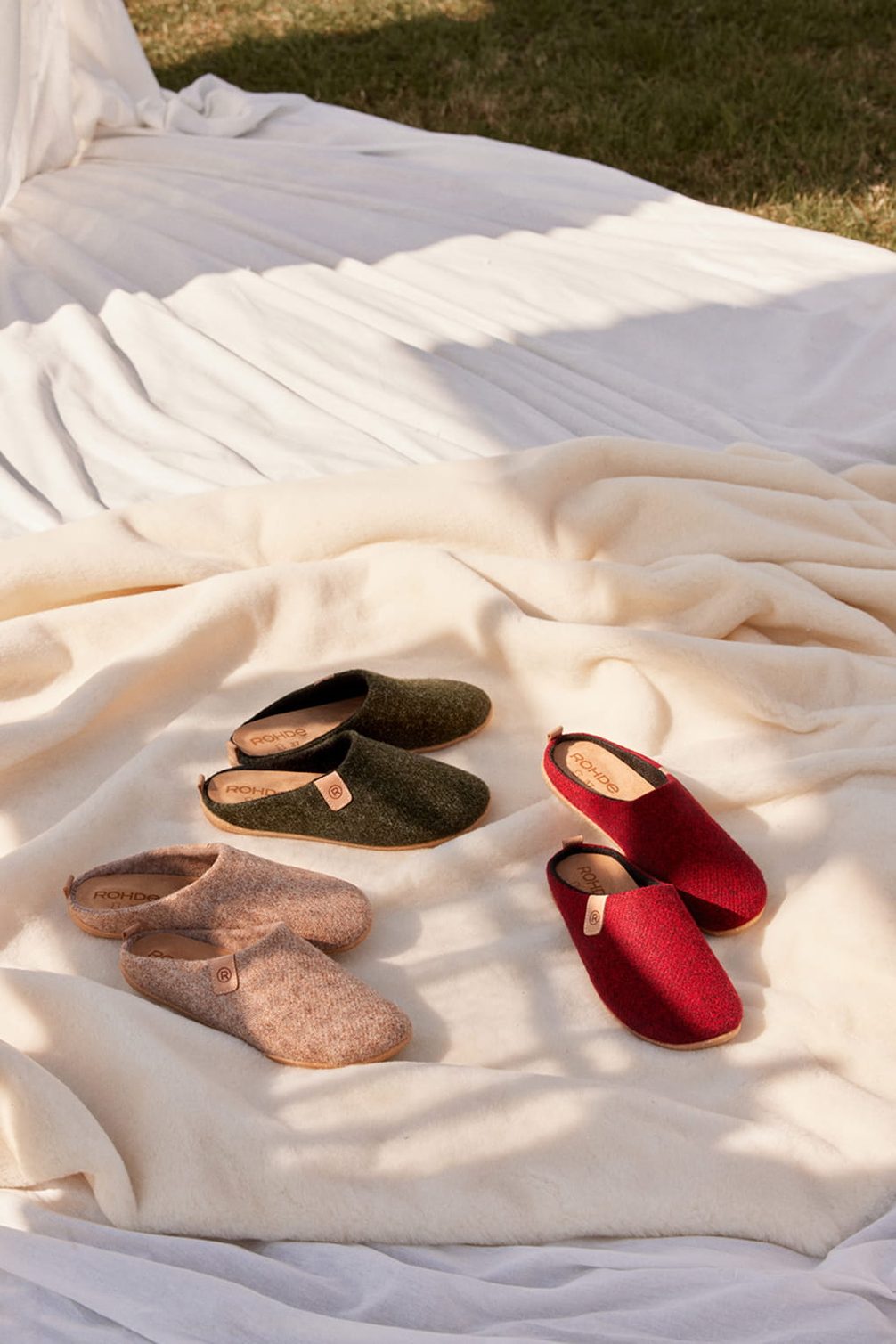 Rohde slippers in green, beige, and red.