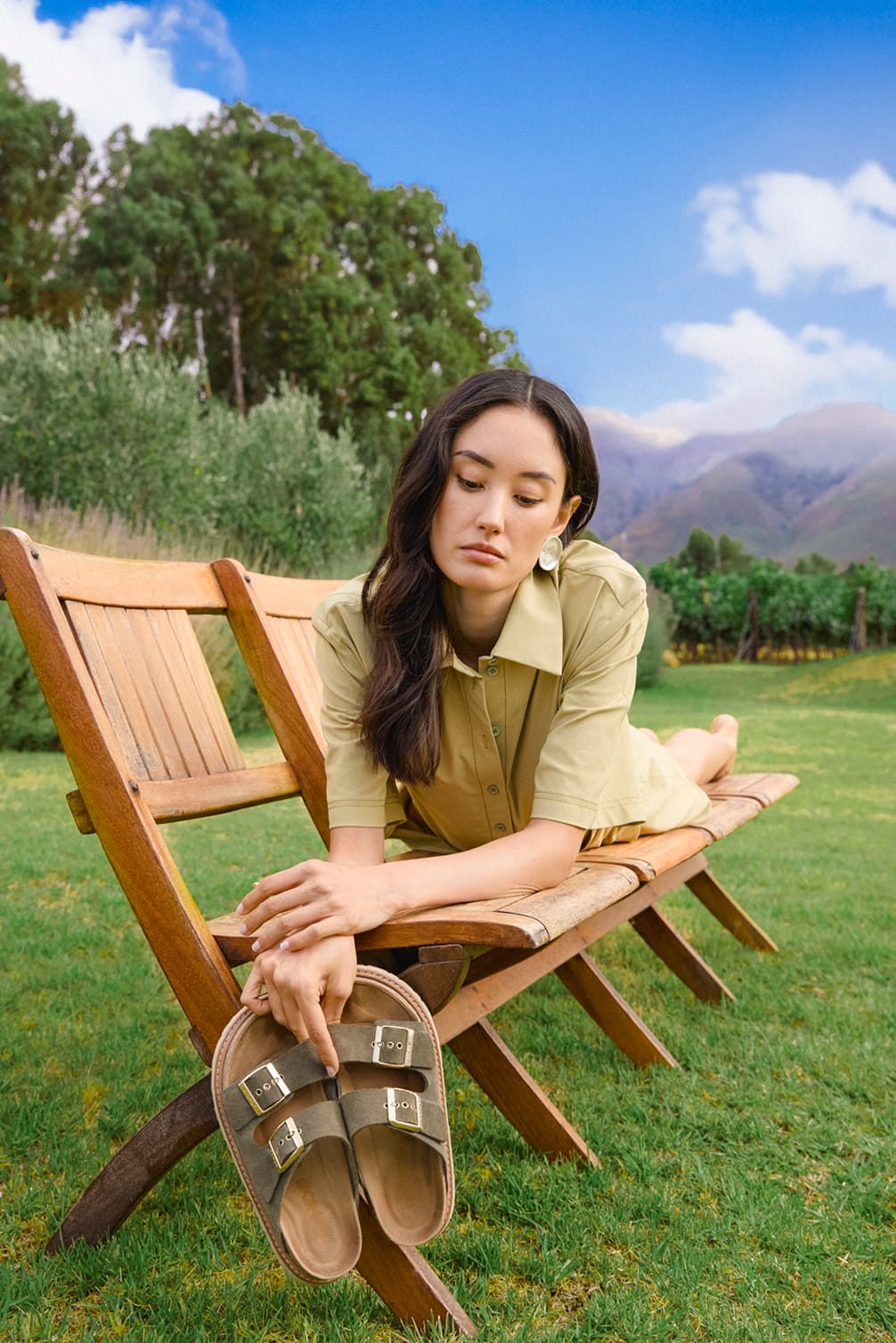 Woman with sandals on a wooden bench outdoors
